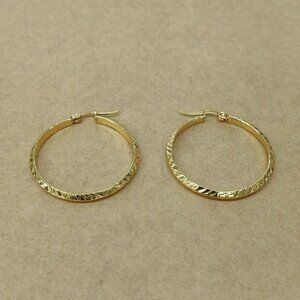Stainless steel earrings , new with tags , color gold